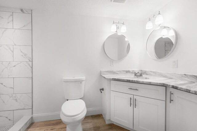 991 SW 31st St, Fort Lauderdale, FL 33315 - bathroom with toilet, wood finished floors, a shower, baseboards, and vanity