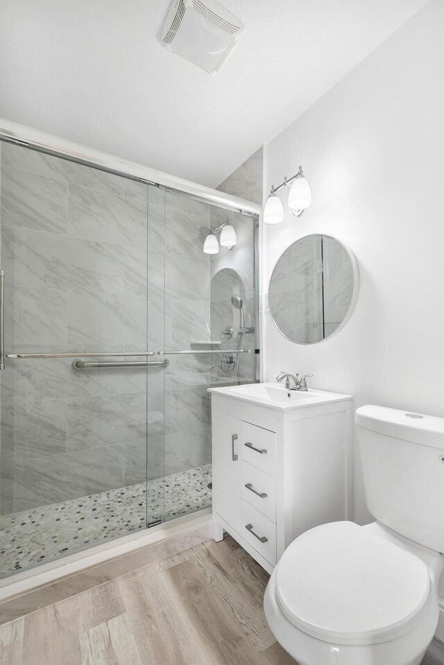 991 SW 31st St, Fort Lauderdale, FL 33315 - full bathroom featuring a stall shower, visible vents, wood finished floors, and vanity