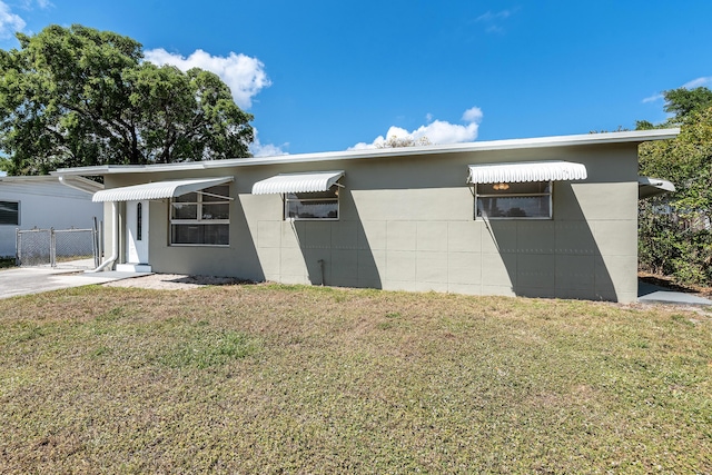 991 SW 31st St, Fort Lauderdale, FL 33315 - view of front of house featuring a gate, concrete block siding, a front yard, and fence