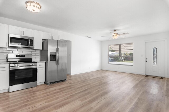 991 SW 31st St, Fort Lauderdale, FL 33315 - kitchen featuring light wood finished floors, ceiling fan, light countertops, decorative backsplash, and stainless steel appliances