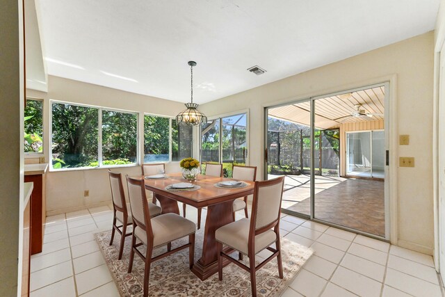 5116 Palm Way, Lake Worth, FL 33463 - dining room with plenty of natural light, light tile patterned floors, a chandelier, and baseboards