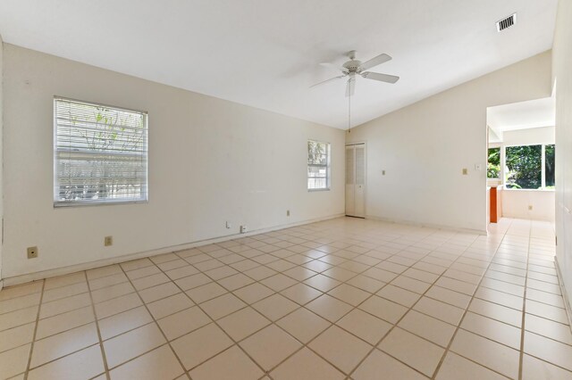 5116 Palm Way, Lake Worth, FL 33463 - unfurnished room featuring a ceiling fan, light tile patterned floors, vaulted ceiling, and baseboards