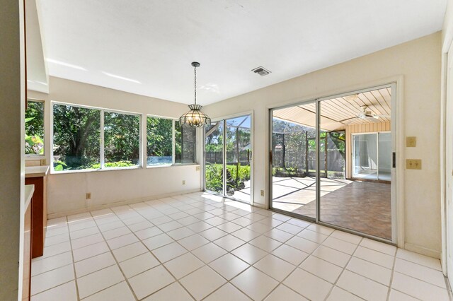 5116 Palm Way, Lake Worth, FL 33463 - unfurnished room with healthy amount of natural light, a chandelier, light tile patterned floors, and baseboards
