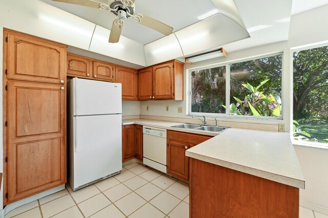 5116 Palm Way, Lake Worth, FL 33463 - kitchen featuring white appliances, a sink, brown cabinetry, light countertops, and light tile patterned floors