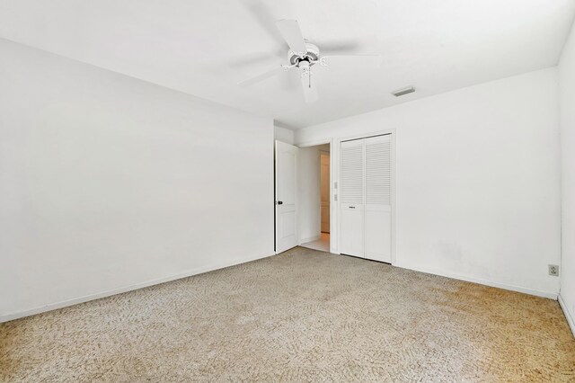 5116 Palm Way, Lake Worth, FL 33463 - unfurnished bedroom with light colored carpet, baseboards, a closet, and a ceiling fan