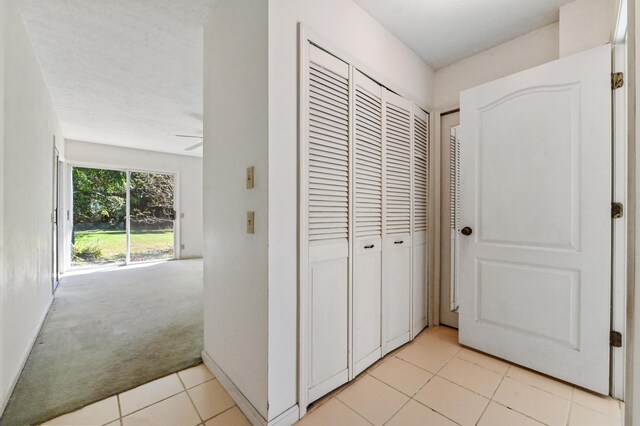 5116 Palm Way, Lake Worth, FL 33463 - corridor featuring light tile patterned flooring and light carpet