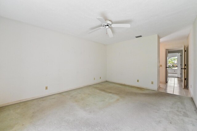 5116 Palm Way, Lake Worth, FL 33463 - empty room with light carpet, a ceiling fan, and baseboards