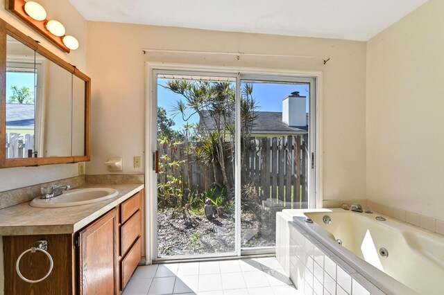 5116 Palm Way, Lake Worth, FL 33463 - bathroom featuring plenty of natural light, a tub with jets, vanity, and tile patterned flooring