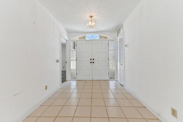 5116 Palm Way, Lake Worth, FL 33463 - foyer with a chandelier, light tile patterned flooring, and baseboards