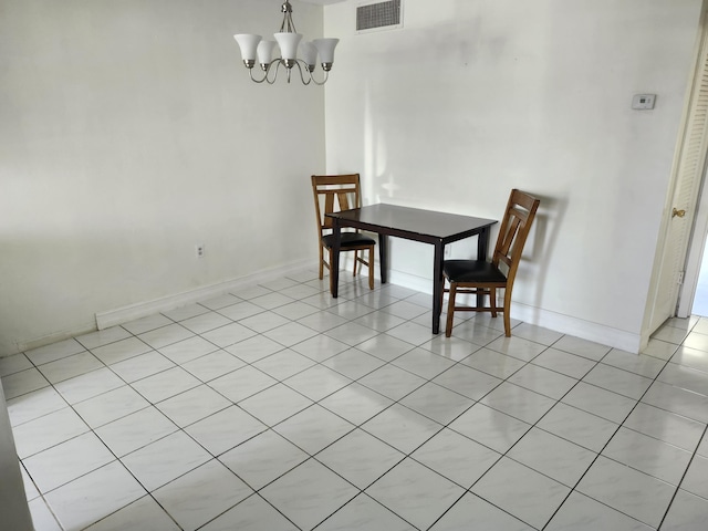 dining room with an inviting chandelier, baseboards, and visible vents