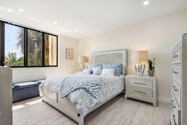 bedroom with recessed lighting, light wood-style floors, and baseboards