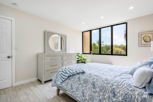 bedroom with light wood-style flooring, recessed lighting, and baseboards