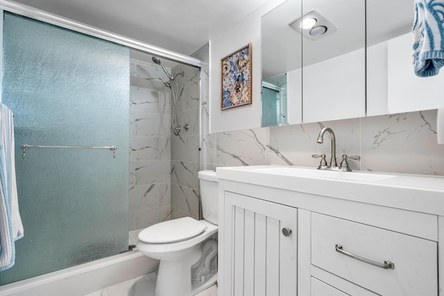 full bath featuring a marble finish shower, backsplash, tile walls, toilet, and vanity
