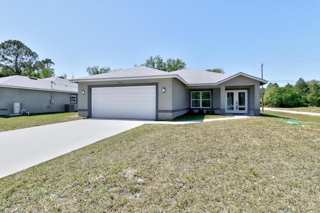 8585 100th Ave, Vero Beach, FL 32967 - ranch-style house featuring french doors, an attached garage, a front lawn, concrete driveway, and stucco siding