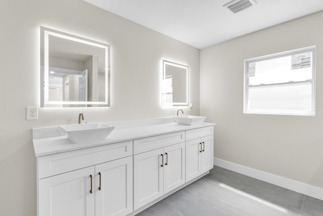 8585 100th Ave, Vero Beach, FL 32967 - bathroom featuring double vanity and baseboards