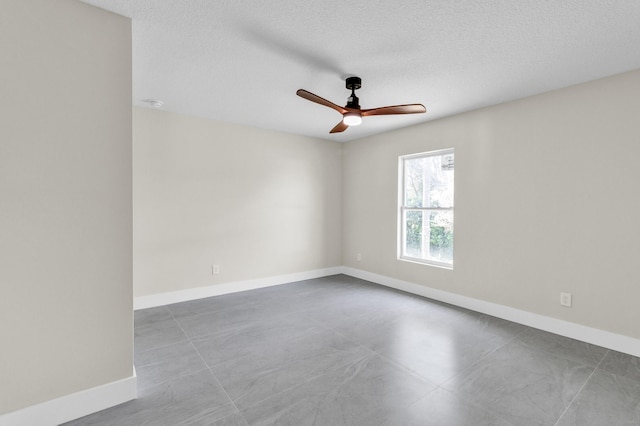 8585 100th Ave, Vero Beach, FL 32967 - empty room featuring ceiling fan, baseboards, and a textured ceiling