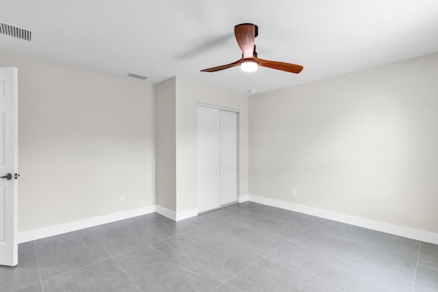 8585 100th Ave, Vero Beach, FL 32967 - unfurnished bedroom with a closet, a ceiling fan, and baseboards