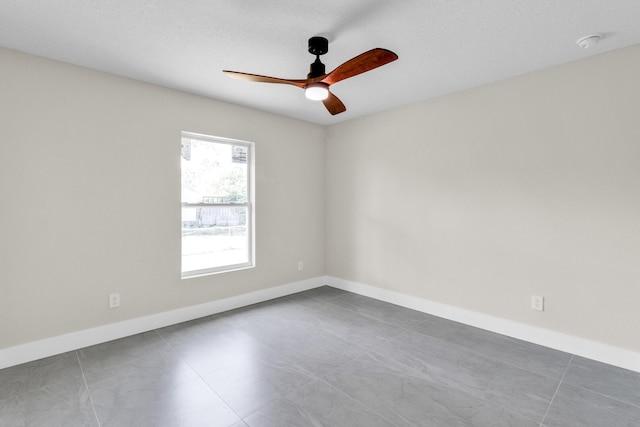 8585 100th Ave, Vero Beach, FL 32967 - empty room with ceiling fan, tile patterned flooring, baseboards, and a smoke detector