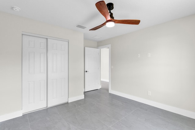 8585 100th Ave, Vero Beach, FL 32967 - unfurnished bedroom featuring a closet, baseboards, and a ceiling fan