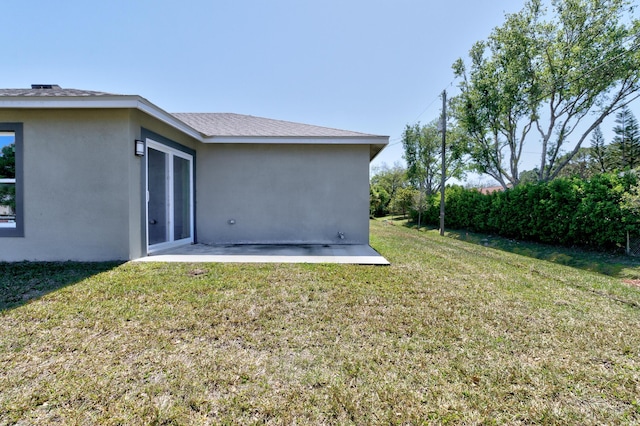 8585 100th Ave, Vero Beach, FL 32967 - rear view of property featuring a lawn, stucco siding, and a patio