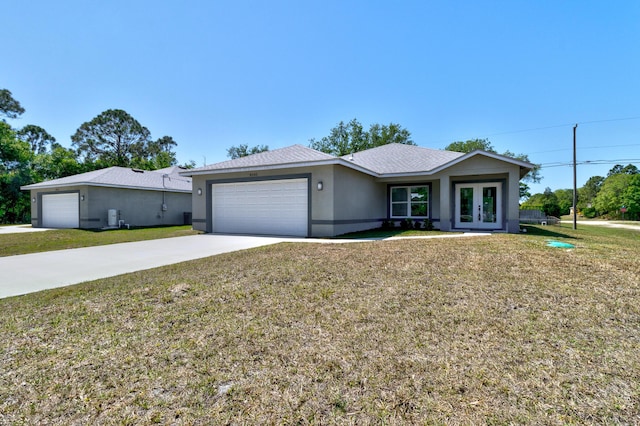 8585 100th Ave, Vero Beach, FL 32967 - ranch-style home with french doors, an attached garage, driveway, and a front yard
