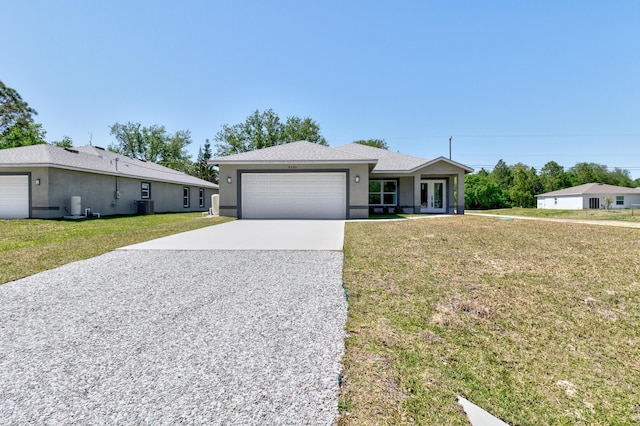 8585 100th Ave, Vero Beach, FL 32967 - ranch-style house featuring driveway, french doors, a front lawn, stucco siding, and an attached garage