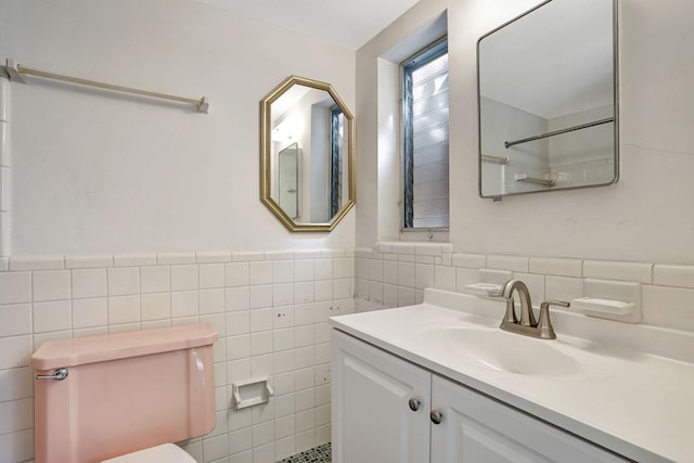 3212 NE 8th Ct Unit 7, Pompano Beach, FL 33062 - full bathroom featuring tile walls, toilet, vanity, wainscoting, and a shower