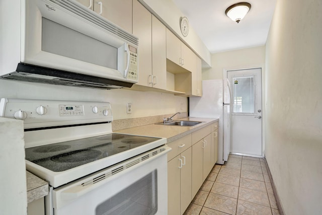 3212 NE 8th Ct Unit 7, Pompano Beach, FL 33062 - kitchen with white appliances, a sink, light countertops, and baseboards