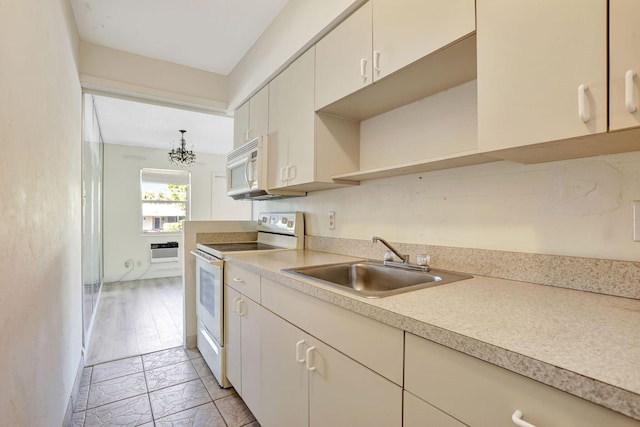 3212 NE 8th Ct Unit 7, Pompano Beach, FL 33062 - kitchen with white appliances, a sink, light countertops, open shelves, and light marble finish floors