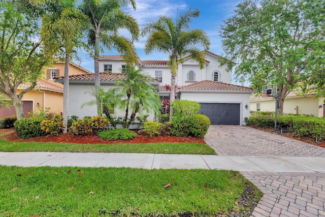 3434 Vanderbilt Dr, Wellington, FL 33414 - mediterranean / spanish-style home featuring a tiled roof, decorative driveway, a garage, and stucco siding