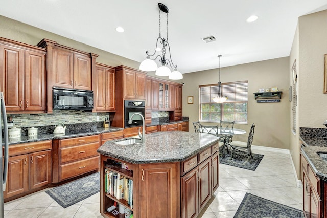 3434 Vanderbilt Dr, Wellington, FL 33414 - kitchen with a sink, visible vents, backsplash, and black appliances