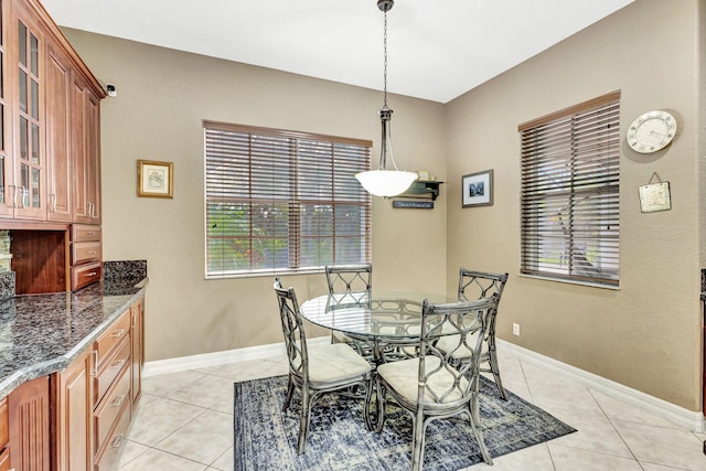 3434 Vanderbilt Dr, Wellington, FL 33414 - dining space with light tile patterned floors, baseboards, and plenty of natural light