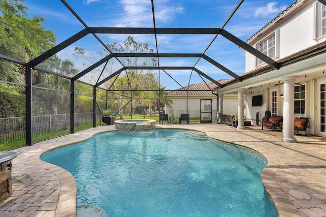 3434 Vanderbilt Dr, Wellington, FL 33414 - view of swimming pool with glass enclosure, a patio, fence, and a pool with connected hot tub