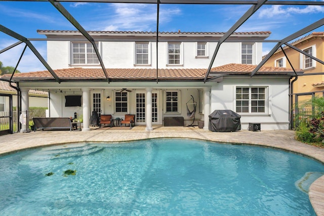 3434 Vanderbilt Dr, Wellington, FL 33414 - back of property featuring stucco siding, a tile roof, a lanai, and a patio area