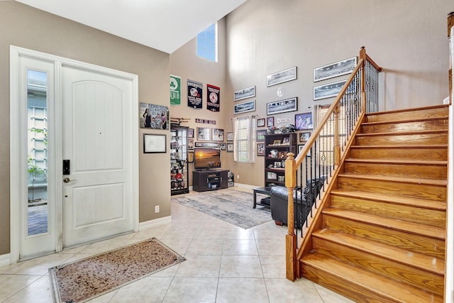3434 Vanderbilt Dr, Wellington, FL 33414 - entryway with light tile patterned flooring, baseboards, stairs, and a towering ceiling