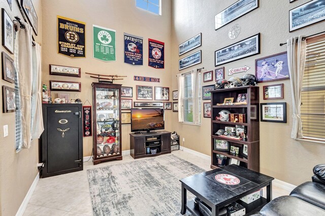 3434 Vanderbilt Dr, Wellington, FL 33414 - living room featuring tile patterned floors, baseboards, and a high ceiling