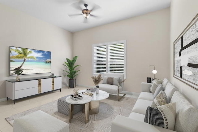 living area featuring baseboards, light tile patterned floors, and a ceiling fan