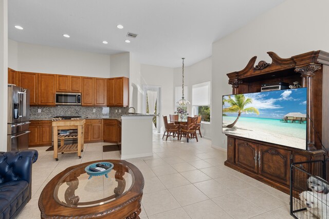 kitchen with light tile patterned floors, visible vents, backsplash, and stainless steel appliances