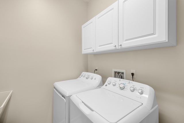 laundry room featuring washer and clothes dryer and cabinet space