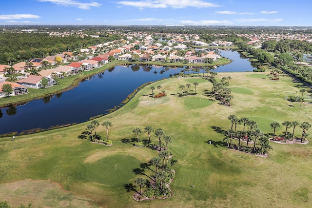 drone / aerial view featuring view of golf course, a residential view, and a water view