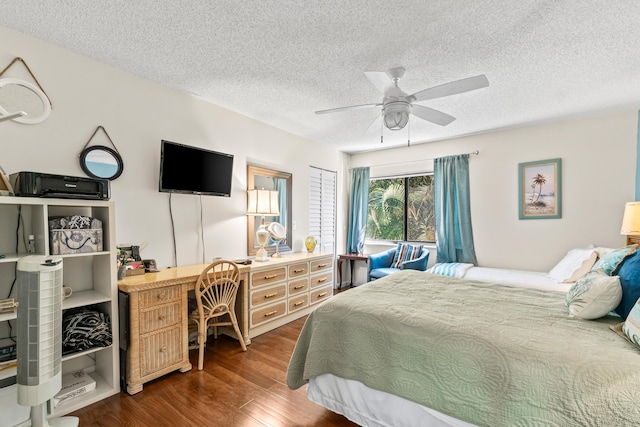 bedroom featuring ceiling fan, a textured ceiling, and wood finished floors