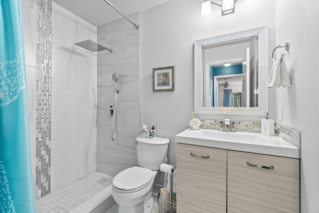 bathroom with vanity, toilet, and a tile shower