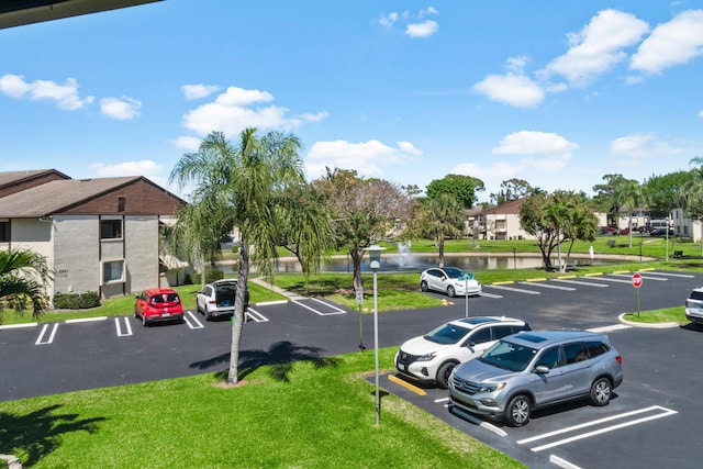 uncovered parking lot featuring a residential view