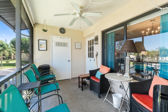 sunroom / solarium with ceiling fan with notable chandelier and visible vents