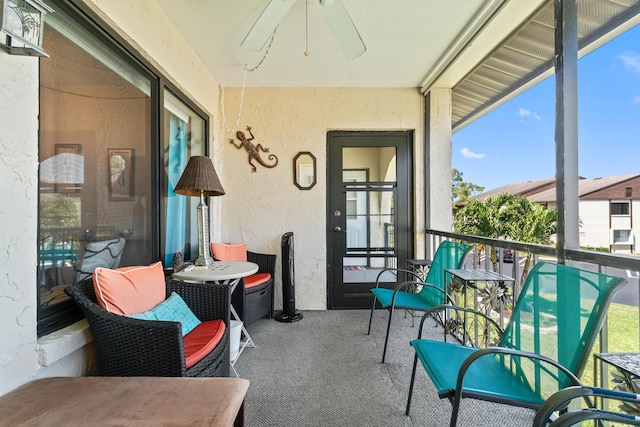 sunroom / solarium featuring a ceiling fan