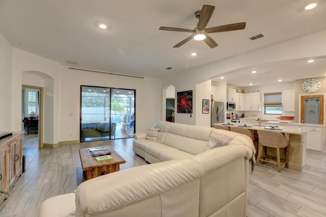 5561 1st Sq SW, Vero Beach, FL 32968 - living area featuring arched walkways, visible vents, and a ceiling fan