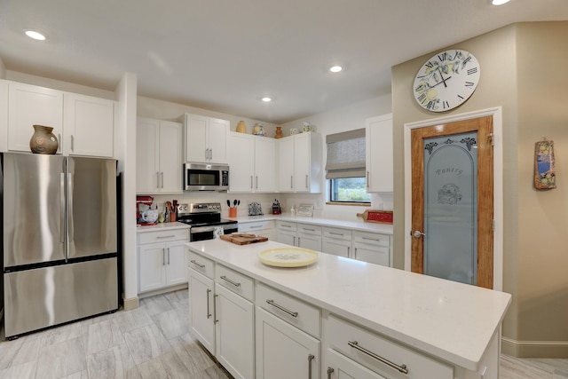 5561 1st Sq SW, Vero Beach, FL 32968 - kitchen featuring white cabinetry, recessed lighting, stainless steel appliances, and light countertops