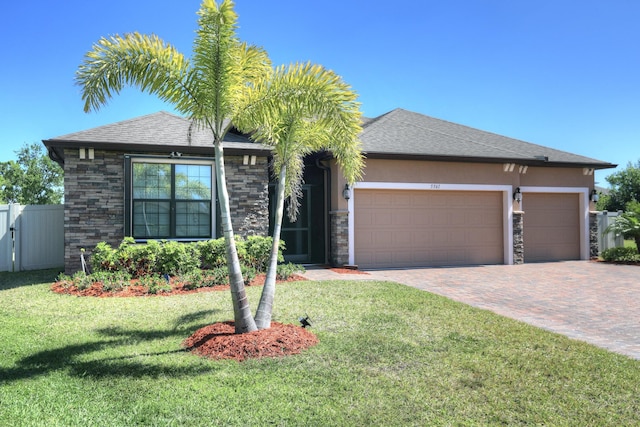 5561 1st Sq SW, Vero Beach, FL 32968 - view of front of home featuring stone siding, a front yard, decorative driveway, and stucco siding