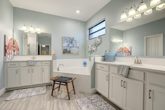 5561 1st Sq SW, Vero Beach, FL 32968 - bathroom with two vanities, a sink, a stall shower, and a garden tub