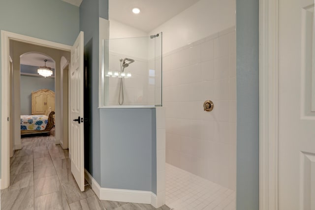 5561 1st Sq SW, Vero Beach, FL 32968 - full bath featuring baseboards, ensuite bath, vaulted ceiling, and walk in shower